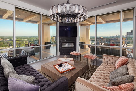 a living room with a couch and a coffee table and a fireplace